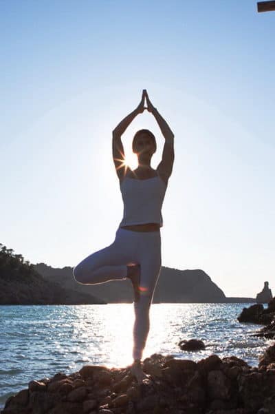 Opale-in-Vikrasana-tree-pose-at-beniras-beach-Hatha-Yoga-Ibiza-400x601